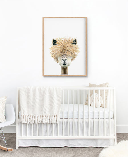 drawing of an alpaca in a timber frame hanging over a white cot in a nursery