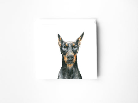 a drawing of a Doberman in colour pencil on a blank greeting card