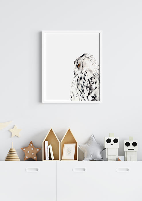  black and white colour pencil drawing of a snowy white owl in a white frame hanging above a white cabinet covered in kids bedroom decor