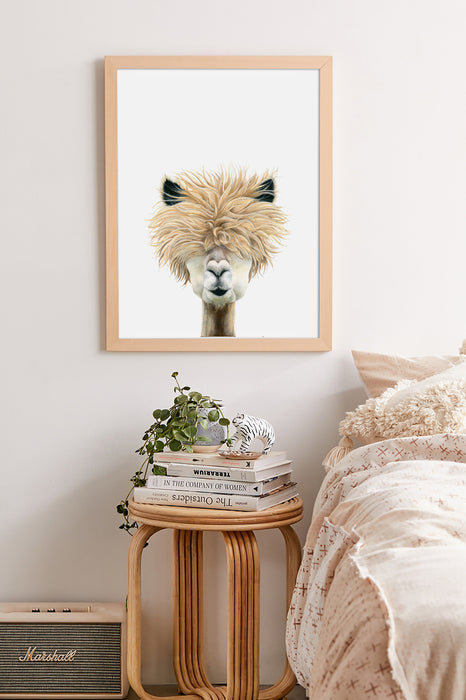drawing of a llama in a timber frame hanging in a bedroom above a side table