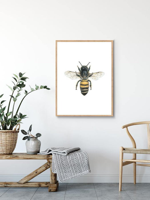 Bee Art Print hanging in a wooden frame above a timber bench - the wild woods