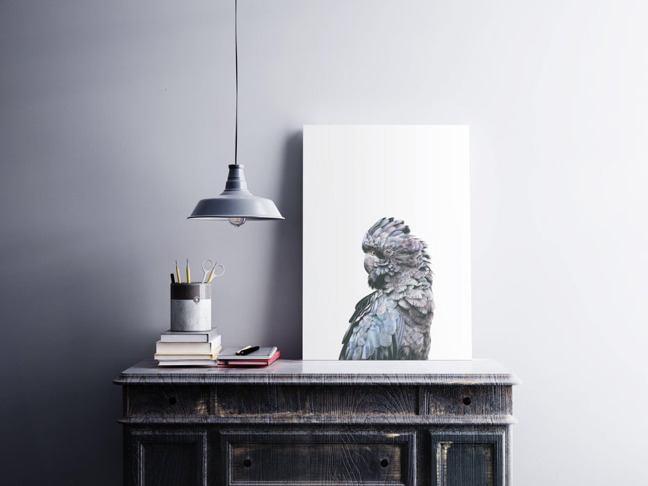 Black Cockatoo Art Print sitting on top of a side table - the wild woods