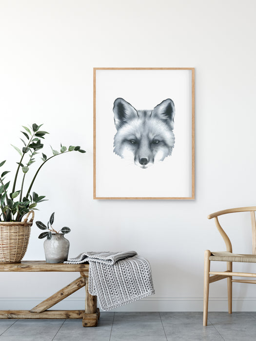 black and white art print of a portrait of a fox in a teak frame hanging on a wall above a timber bench