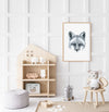black and white art print of a portrait of a fox in a teak frame hanging on a wall in a children's play room