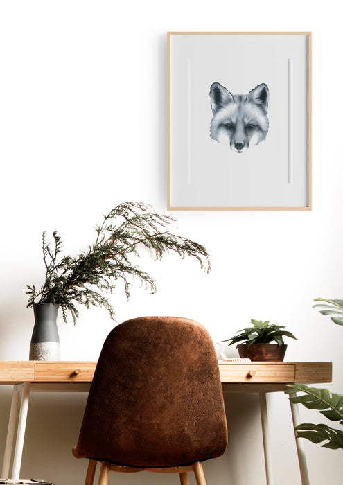 black and white art print of a portrait of a fox in a teak frame hanging on a wall in an office above a desk with a brown chair