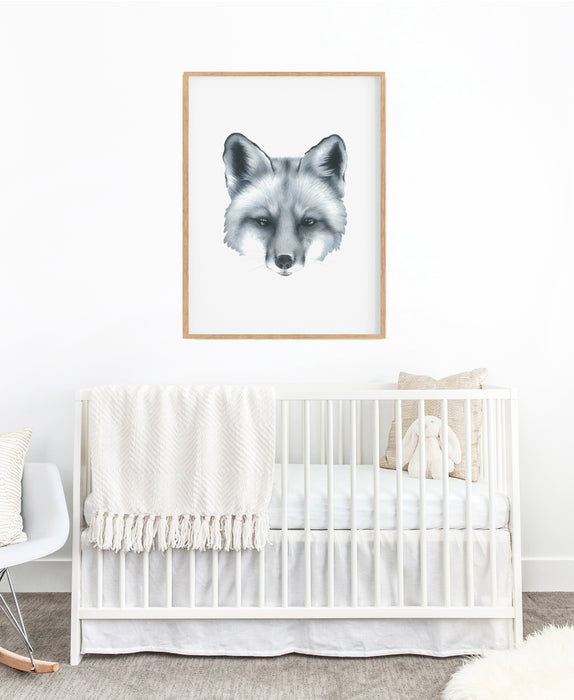 black and white art print of a portrait of a fox in a teak frame hanging on a wall in a children's nursery above a white cot