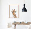 colour pencil drawing of a giraffe on a white background in a teak frame hanging in a kitchen above a timber table