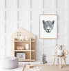 black and white drawing of a leopards portrait  in a timber frame hanging in a children's bedroom