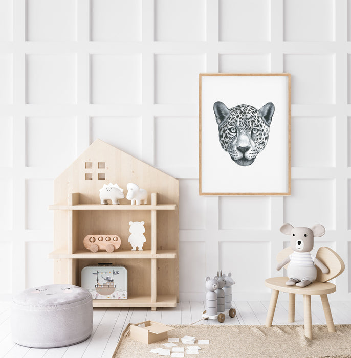 black and white drawing of a leopards portrait  in a timber frame hanging in a children's bedroom