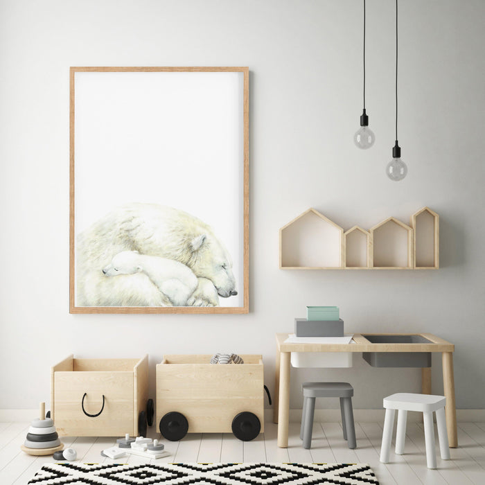 art print of a mother polar bear and a baby in a wooden frame hanging in a kids play room