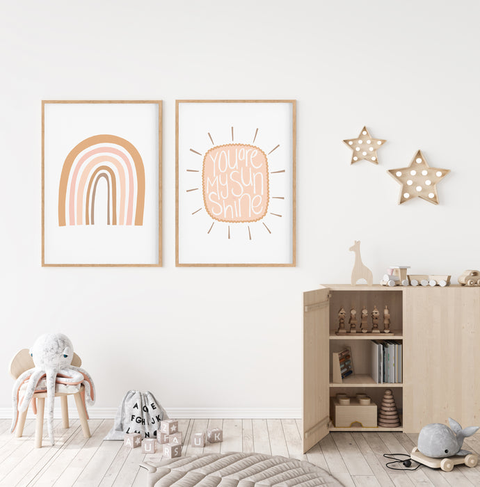 Set of two rainbow and cloud nursery prints hanging  in a childrens room