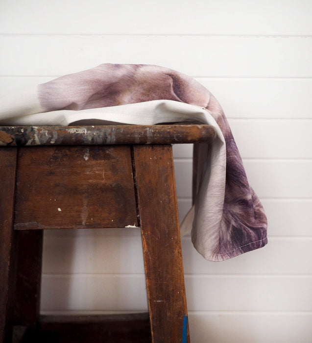 linen tea towel draped over a timber stool