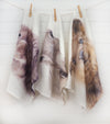 three linen animal print tea towels hanging on a string by pegs
