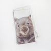 a linen tea towel with a wombat printed on it